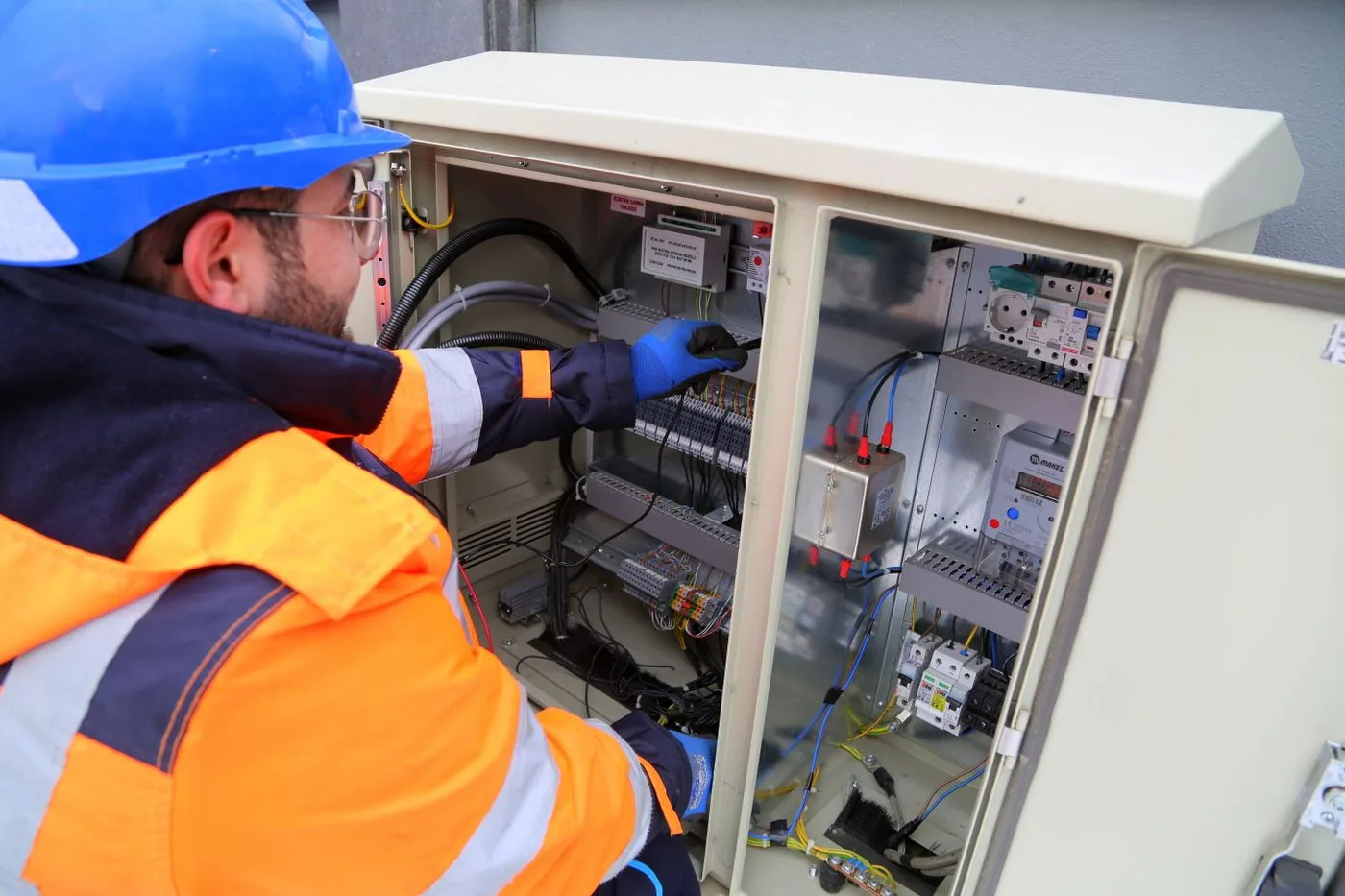 Electrical professional working at a distribution panel